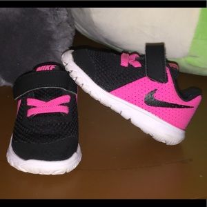 Pink and black Nike toddler shoes.